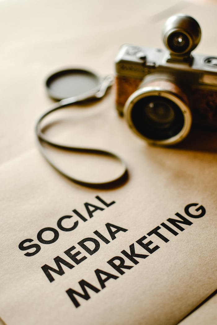 Close-up of a vintage camera on brown paper labeled with 'Social Media Marketing'.